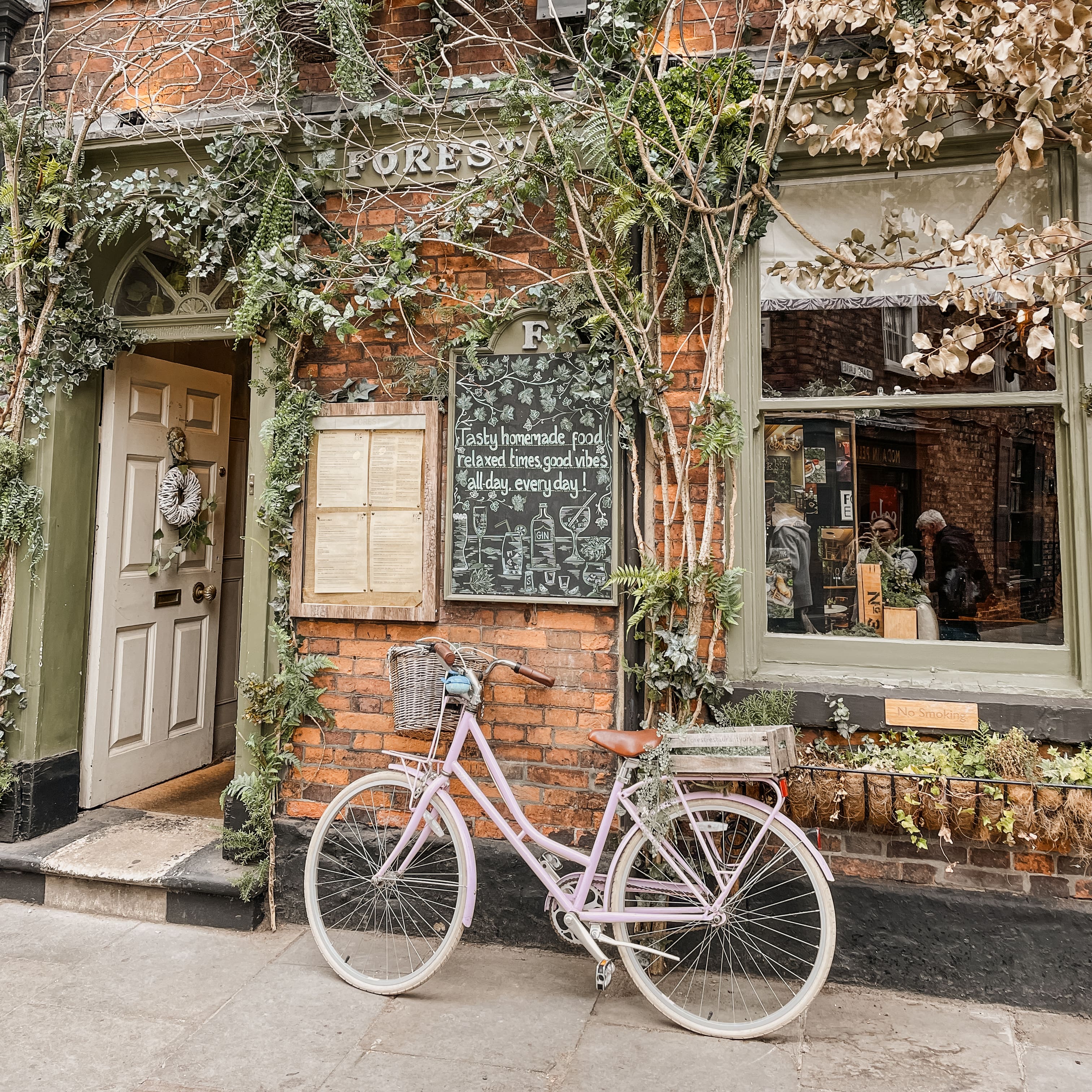 A pink bike in front of a restaurant in York, UK 