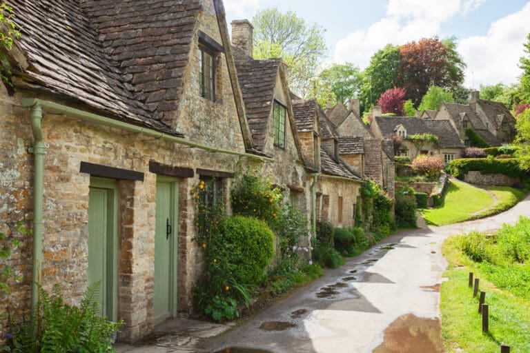 Old street with traditional cottages in beautiful spring day , Bibury, England, UK. moving to the UK as an Occupational therapist